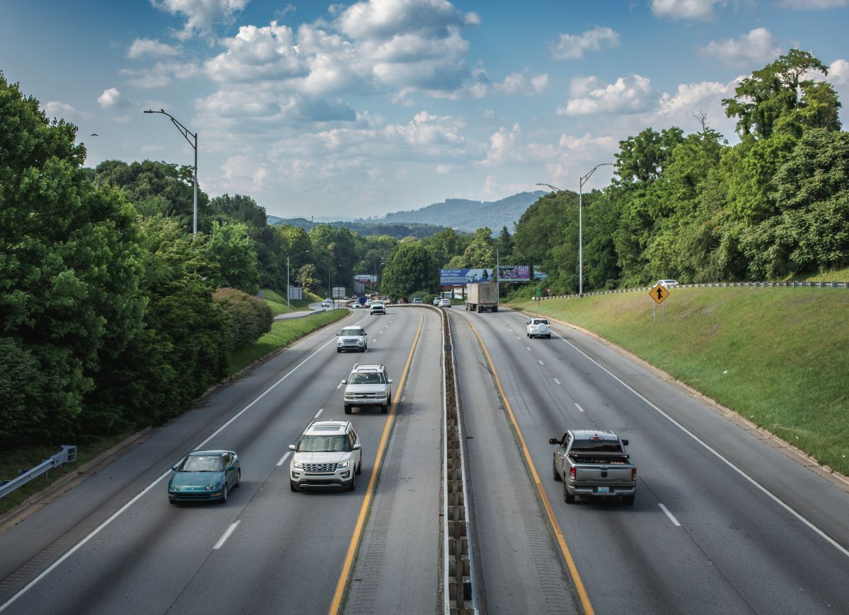 Cars and trucks driving on highway through Western North Carolina mountains