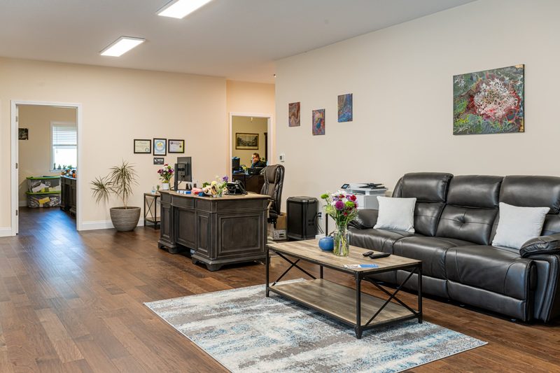 Peterson Insurance Group office lobby with comfortable seating, fresh flowers, and original artwork by Eirene Peterson
